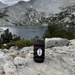Grubcan Bear Canister next to mountain lake