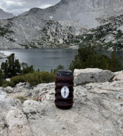 Grubcan Bear Canister next to mountain lake