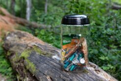 Grubcan Polycarbonite 6.6L Bear Canister on bench in the forest