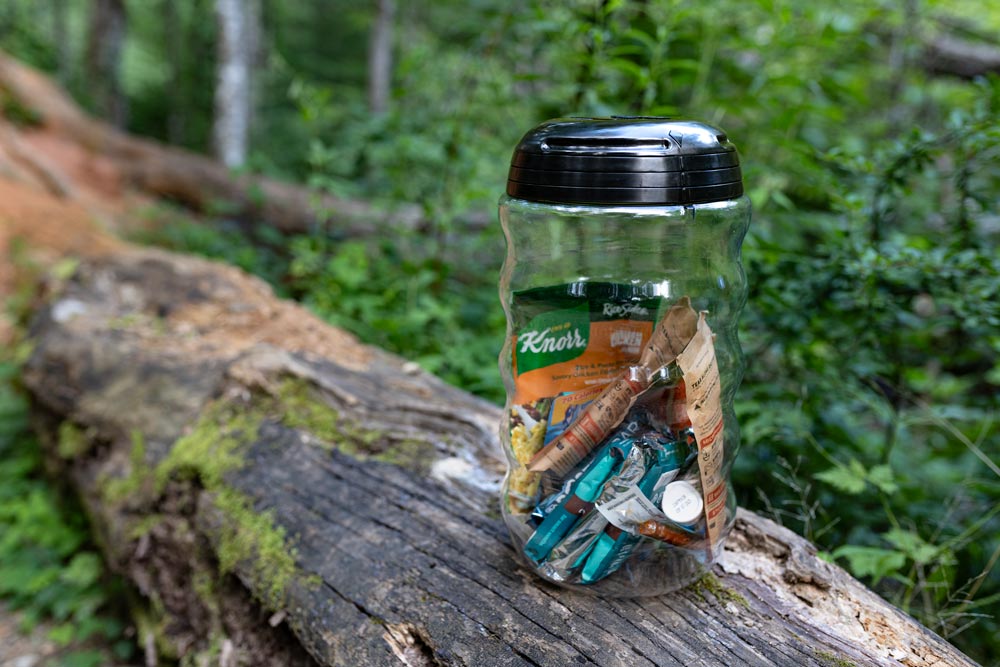 Grubcan Polycarbonite 6.6L Bear Canister on bench in the forest